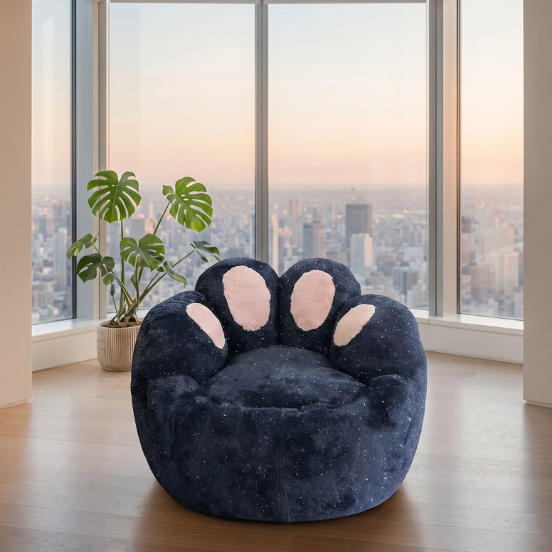 Navy blue kids bean bag chair with a soft paw-shaped design and pink cushions, displayed in a modern apartment with panoramic city views.