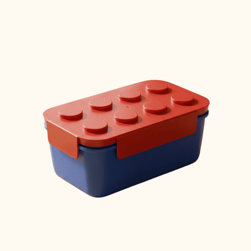 Red lid bento big box japanese with navy blue container and raised stud pattern on neutral white background