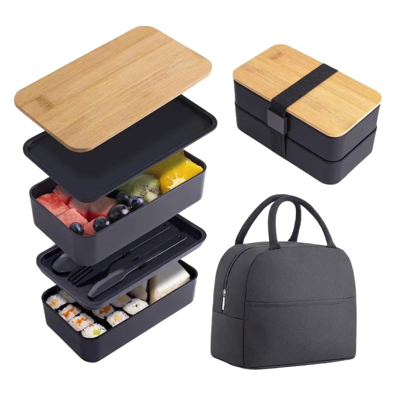 Exploded view of black bento box japanese containers with bamboo lid showing stacked compartments filled with sushi and fruit beside insulated carrying bag