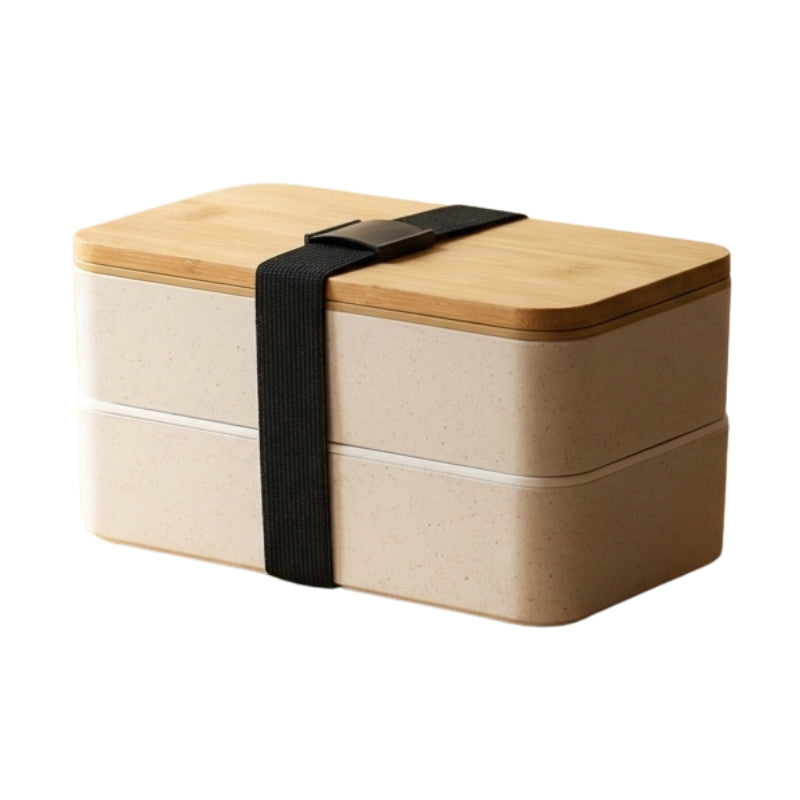 Double-layer beige bento japanese box lunches with bamboo lid and black elastic band on neutral studio background