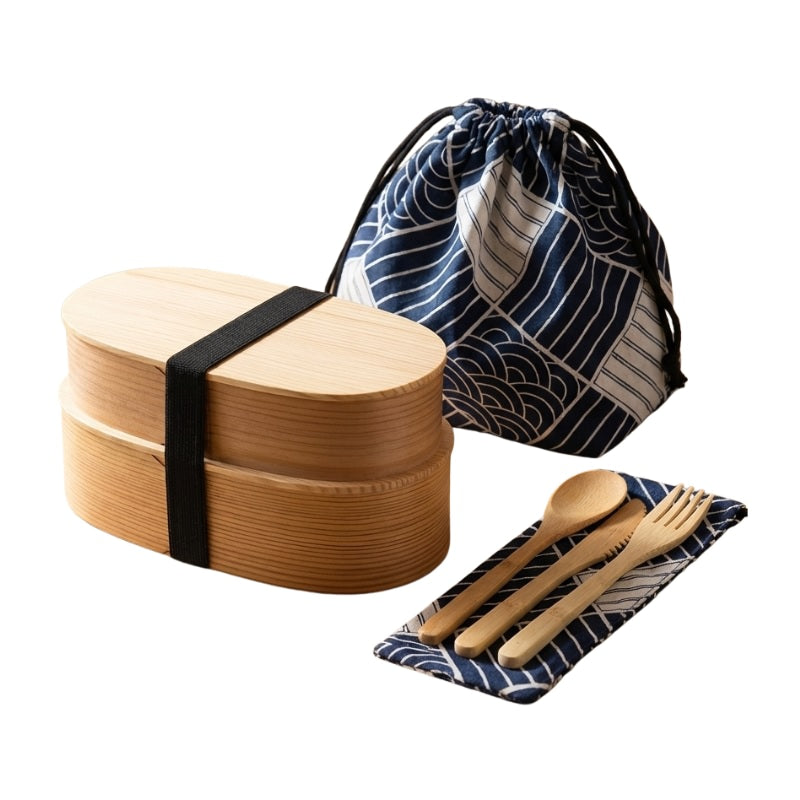 Two-layer natural wood bento japanese food box with large drawstring bag and matching wooden utensils on white studio background