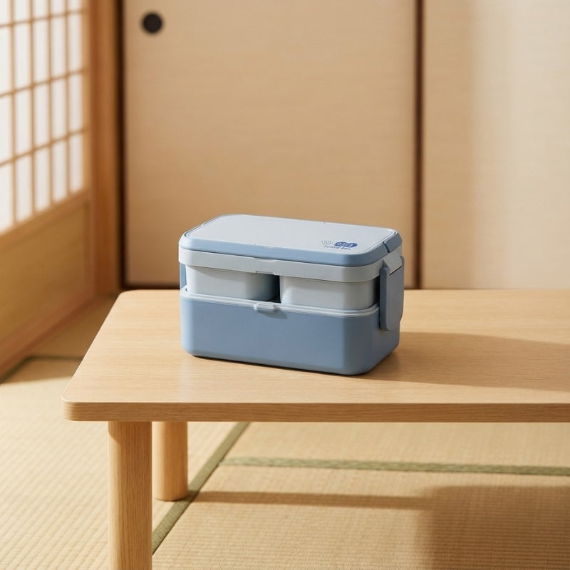 Modern bento kids box with compartments and safety closure on wooden table in traditional Japanese interior setting