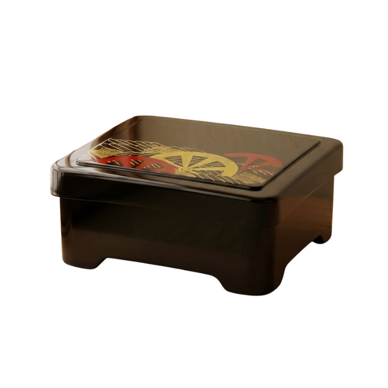 Black sushi bento box with gold with red and gold wheel pattern on neutral background