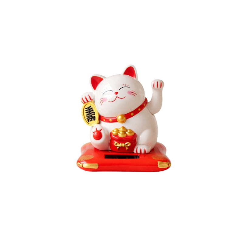 Classic white cat japanese maneki neko with red collar and golden bells waving both paws on red solar base isolated against clean white backdrop