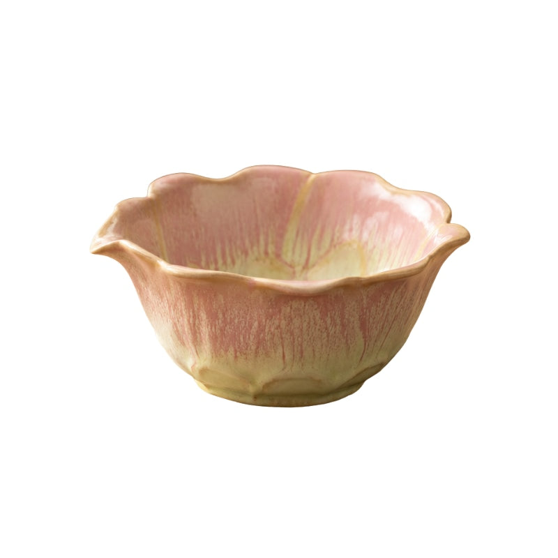 Ceramic Japanese matcha bowl with scalloped lotus flower rim and pink-to-yellow drip glaze on white background