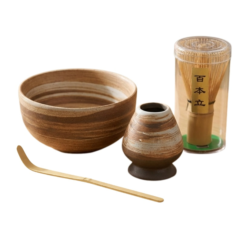 Brown ceremonial matcha set tea with striped bowl bamboo whisk holder and brass scoop on white background
