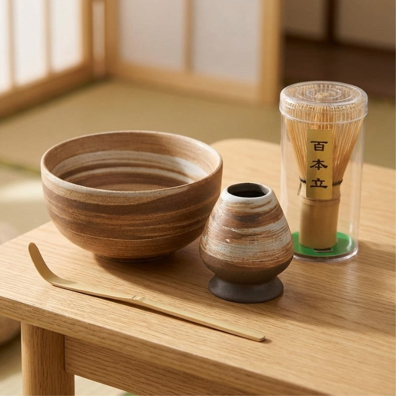 Natural ceremonial matcha tea set with earth tone striped ceramic bowl and tools on wooden table