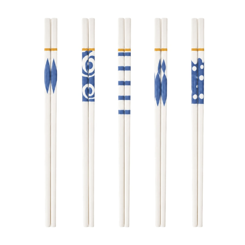 Set of 5 pairs of chopsticks ceramic in white with five different blue geometric patterns and gold accent bands on white background