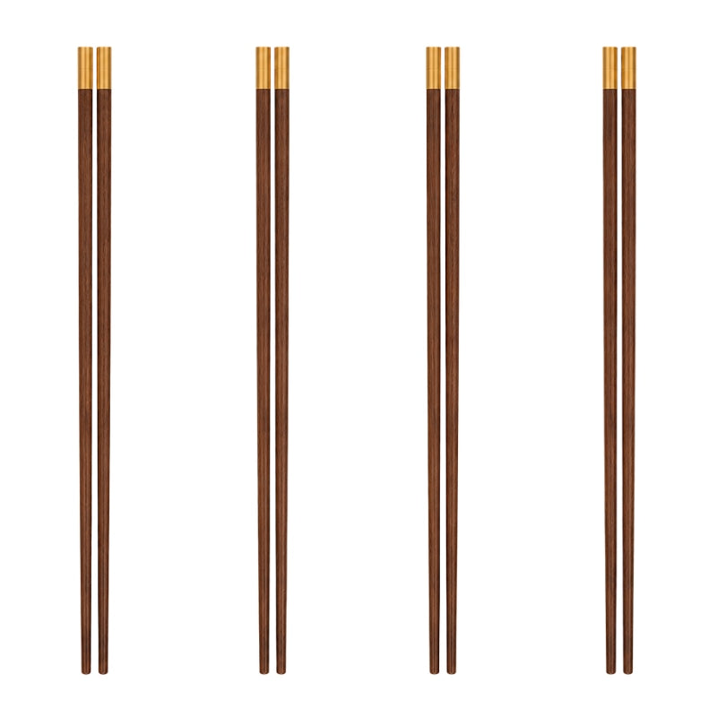 Four pairs of wood chopsticks with gold tips displayed vertically on white background