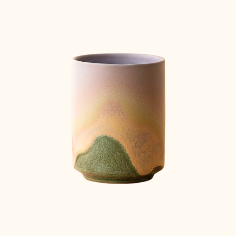 Cup tea japanese set with green mountain landscape glaze rising through beige mist on neutral background