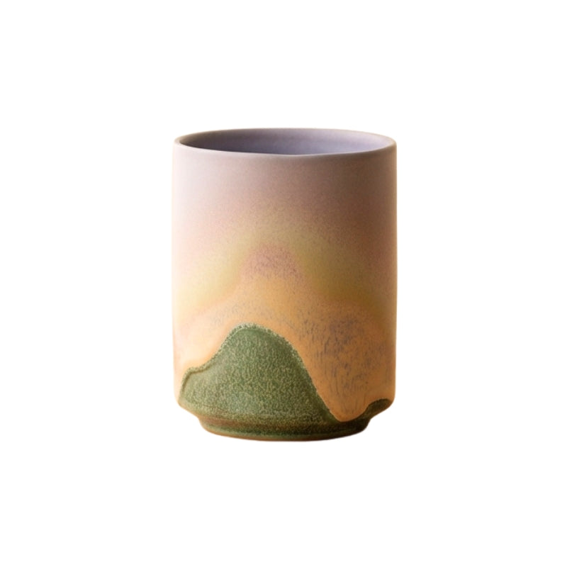 Cup tea japanese set with green mountain landscape glaze rising through beige mist on neutral background