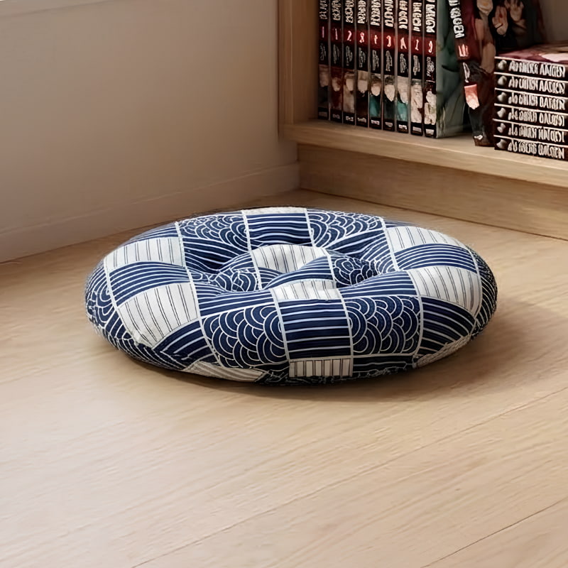 Resting beside a low wooden table on tatami, this Japanese cushion sits directly on the floor in a navy wave pattern