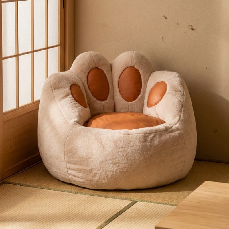 Cute bean bag cat paw chair in beige plush fabric with caramel colored pads on tatami mat floor near shoji sliding door