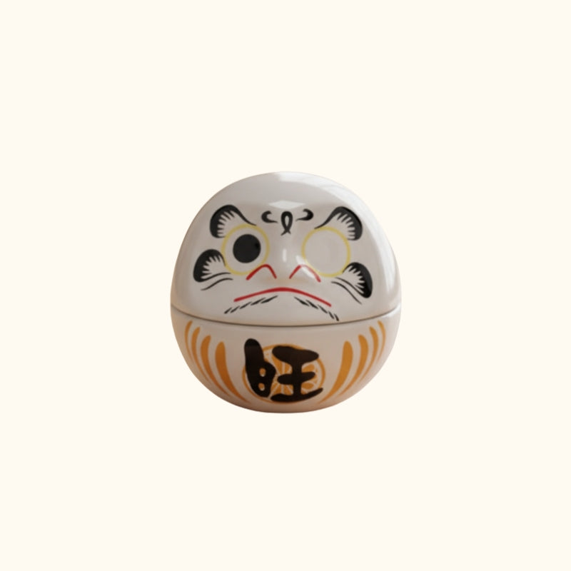 Round daruma white japan featuring traditional fierce expression and orange prosperity symbols on clean white background