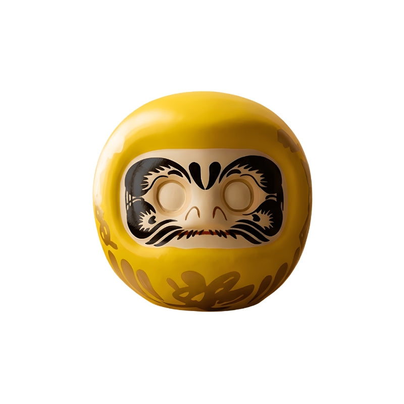 Daruma yellow doll Japan with golden calligraphy and traditional fierce expression for prosperity goals