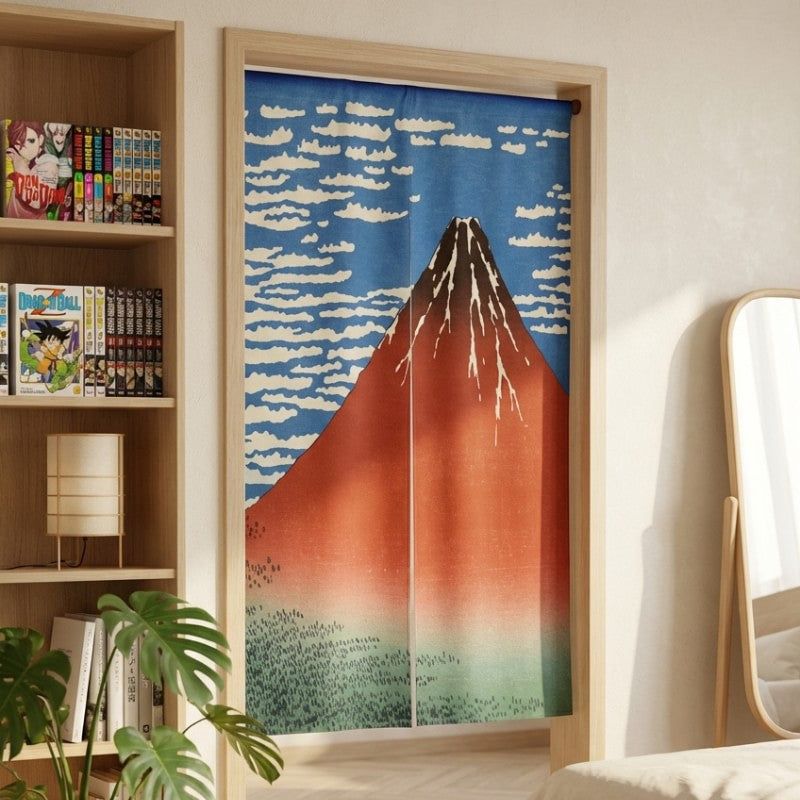 Doorway noren curtain volcano Red Fuji Hokusai design hanging in modern bedroom with manga bookshelf and monstera plant