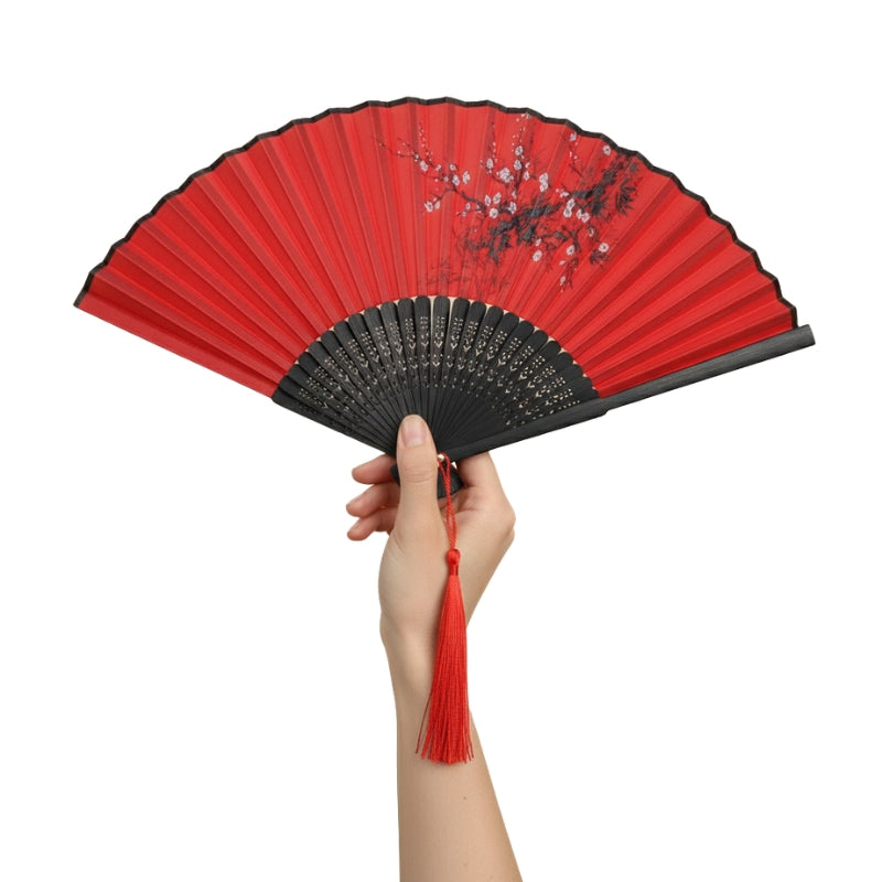 Elegant fan japanese dance in bold red featuring hand-drawn ume blossoms and decorative black bamboo ribs with tassel detail