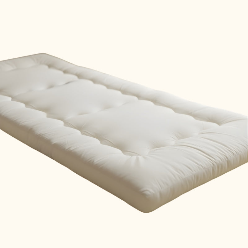 Thick quilted futon japanese traditional with white cotton surface and visible stitching patterns on neutral background