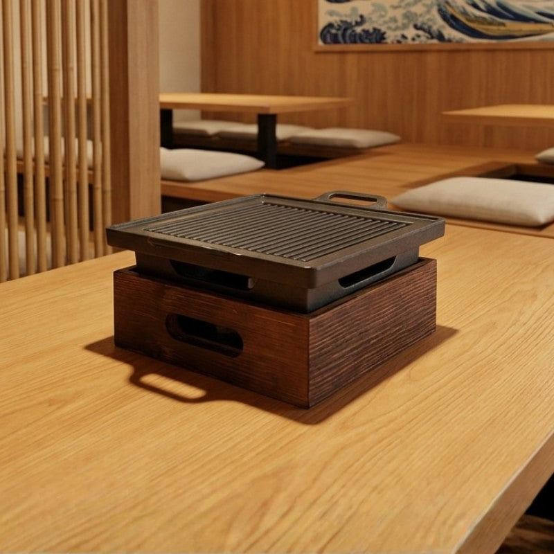 Grill BBQ Japanese design with ribbed surface and wooden base on natural wood table in zen interior setting