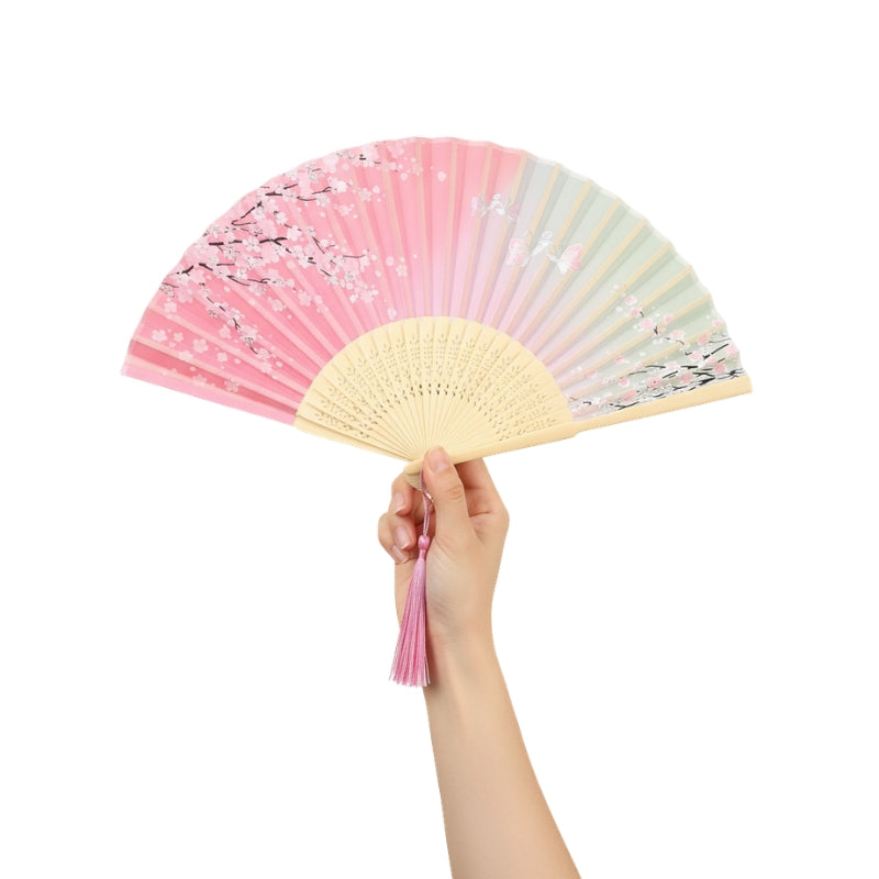 Beautiful hand fan japanese pink featuring sakura branches held gracefully against white backdrop showcasing pastel gradient and carved bamboo details