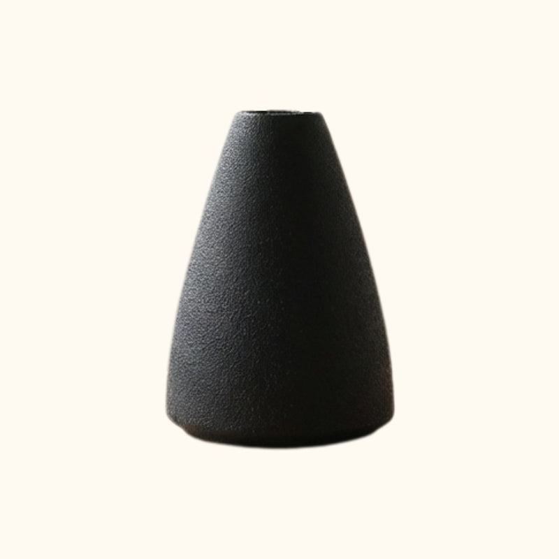 Black textured ceramic ikebana arrangement flower vase with cone shape on clean white background
