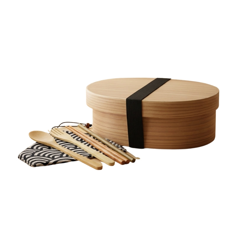 Single-tier light japanese bento wood box with black elastic band and wave-pattern utensil wrap on clean white studio background