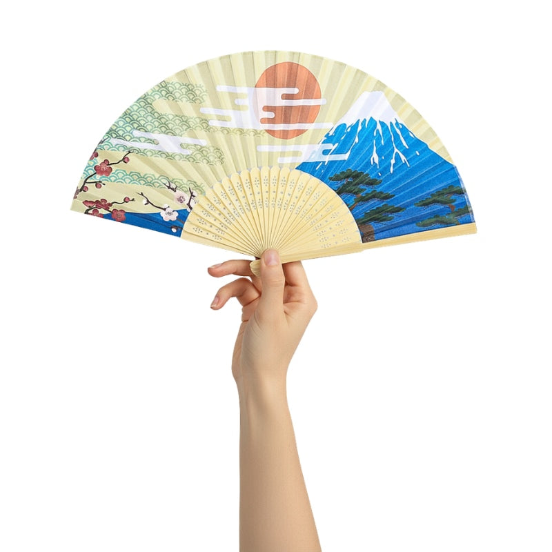 Elegant japanese fan paper featuring Mount Fuji rising sun and plum blossoms held gracefully against white backdrop with carved bamboo frame
