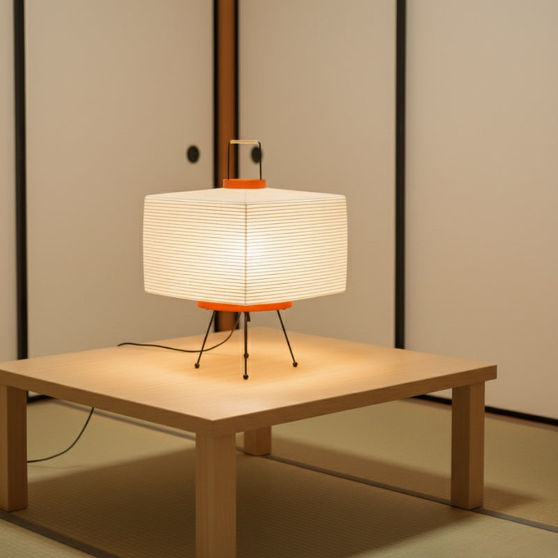 Geometric japanese floor style lamp with cube paper shade glowing on low table near shoji sliding doors in serene setting