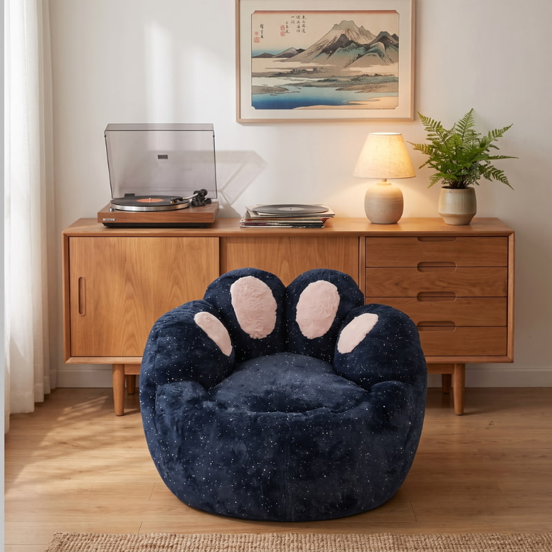 Comfortable kids bean bag chair with a navy blue plush finish and pink paw details in a cozy living room with Japanese wall art.