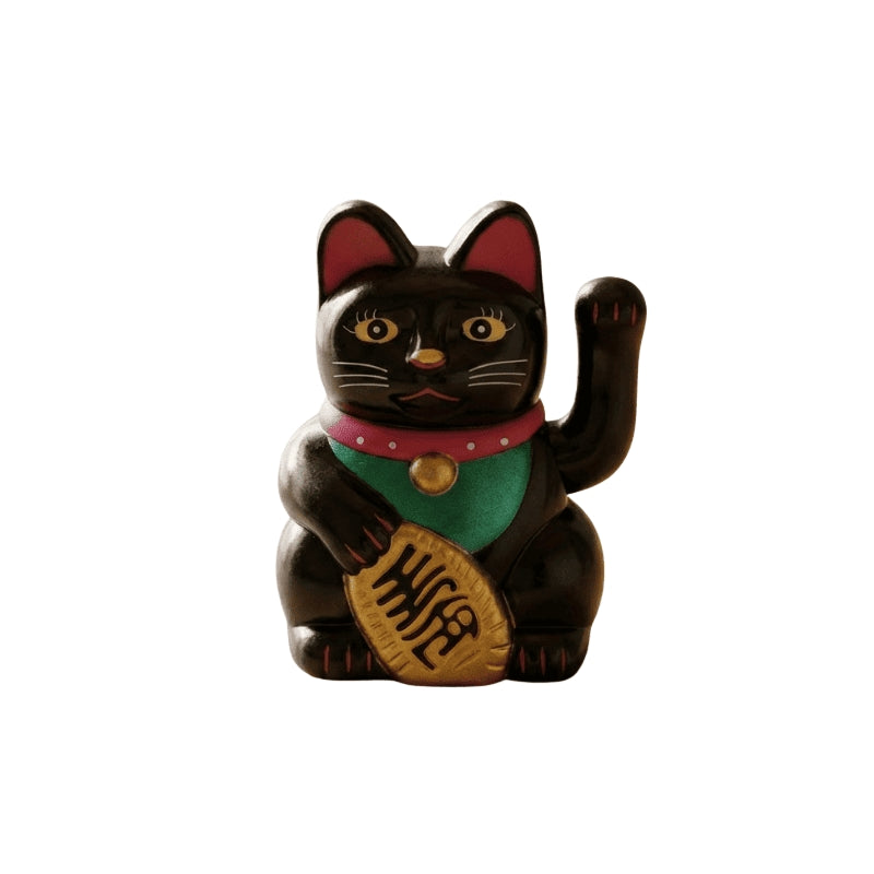 Protective black lucky maneki neko cat statue with raised paw and gold treasure displayed on clean white background