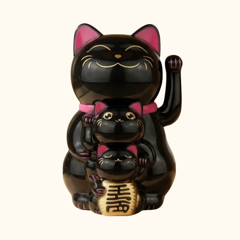 Three tier black maneki neko japanese cute family with pink ears and gold treasure displayed on neutral white background