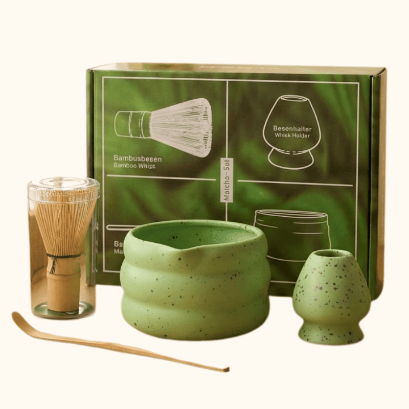 Complete matcha japanese bowl set in sage green ceramic with bamboo whisk and green gift packaging on clean white background
