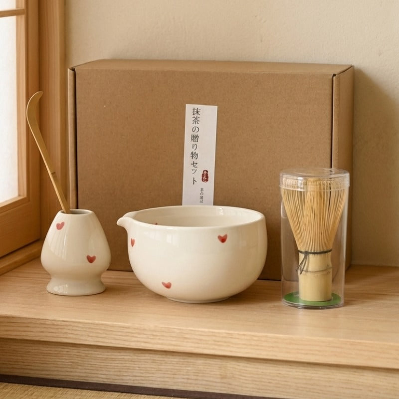 Ivory matcha set tea featuring red hearts with bamboo whisk and gift box in traditional Japanese room