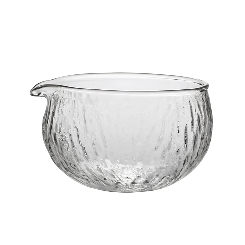 Clear glass matcha tea bowl Japanese style with hammered water-effect texture and small pouring spout on white background