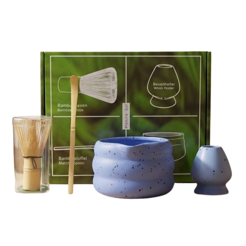 Ocean blue matcha tea whisk japanese set with complete bamboo tools and green illustrated box presented on neutral white background
