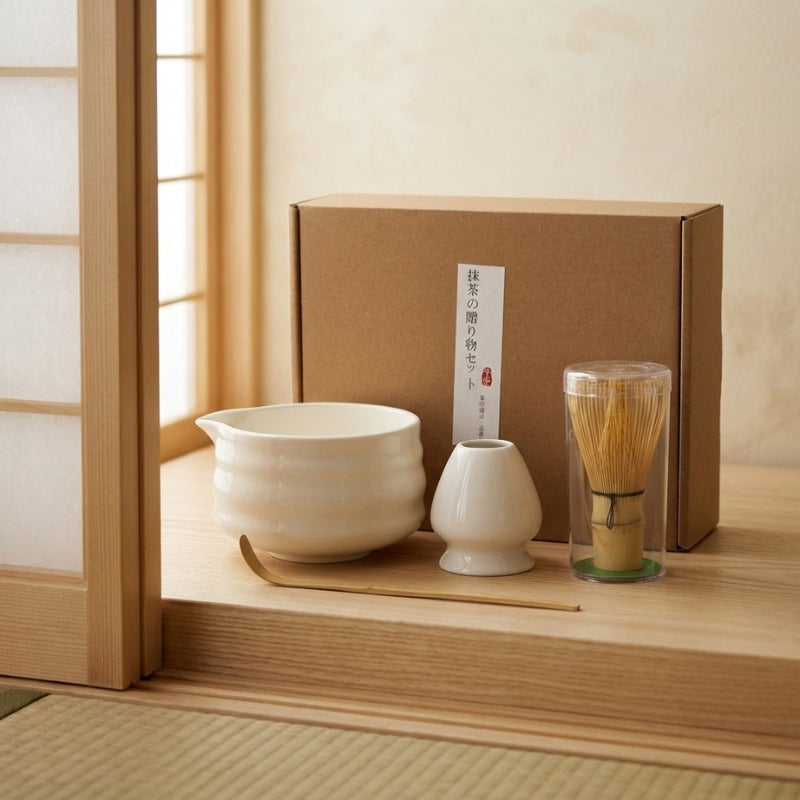 Authentic matcha whisk set japanese with white porcelain pieces and bamboo whisk on wooden platform beside bright window with natural light