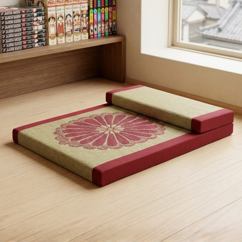 Meditation floor cushion with backrest burgundy fabric chrysanthemum pattern near window with manga bookshelf collection