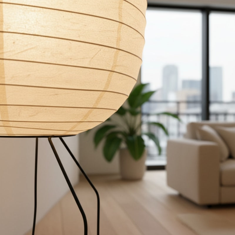 Close up detail of nugochi lamp akari showing textured rice paper pleats and curved organic cocoon shape with minimalist wire base
