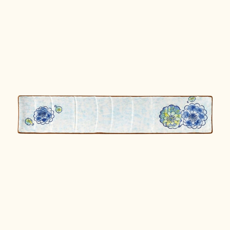 Traditional plate ceramic sushi featuring delicate floral patterns in blue and yellow tones with brown rim edges