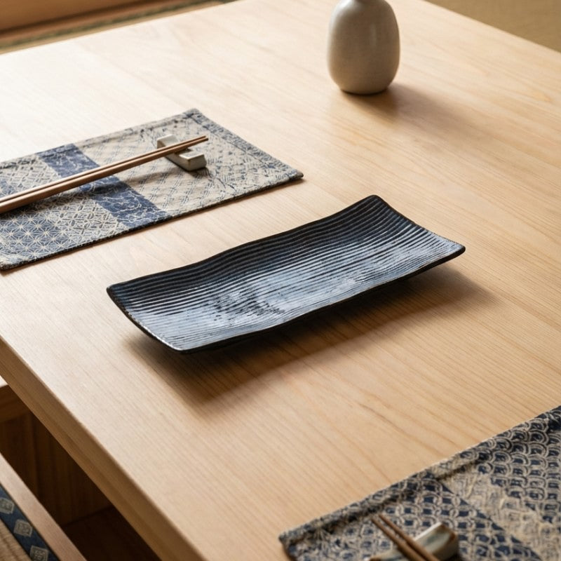 Minimalist plate of sushi blue with linear pattern on natural wood table with geometric table runner