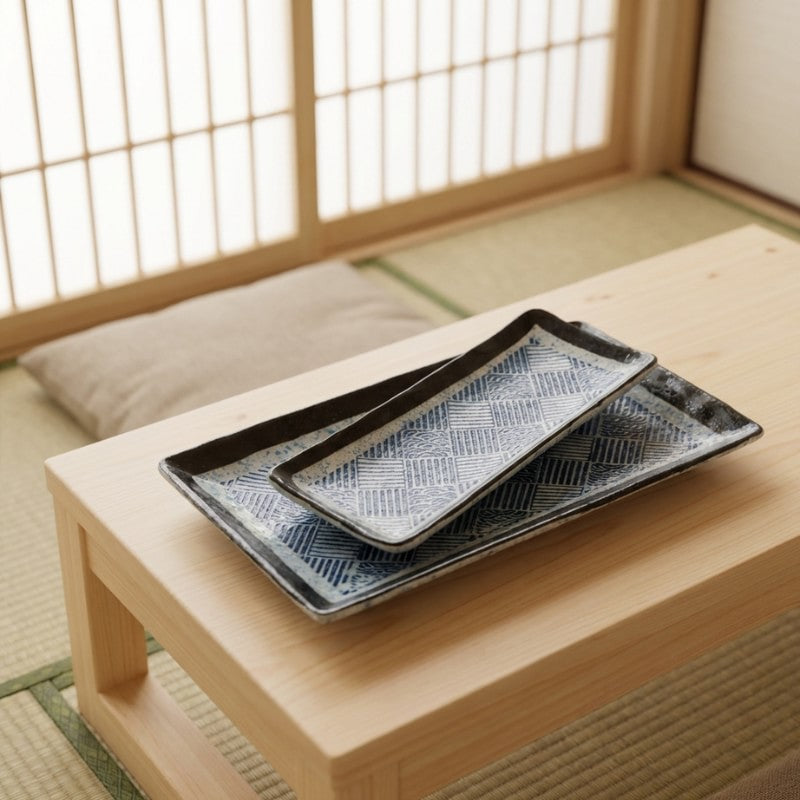 Stacked plate sushi decoration set in various sizes displayed on wooden chabudai in traditional tatami room