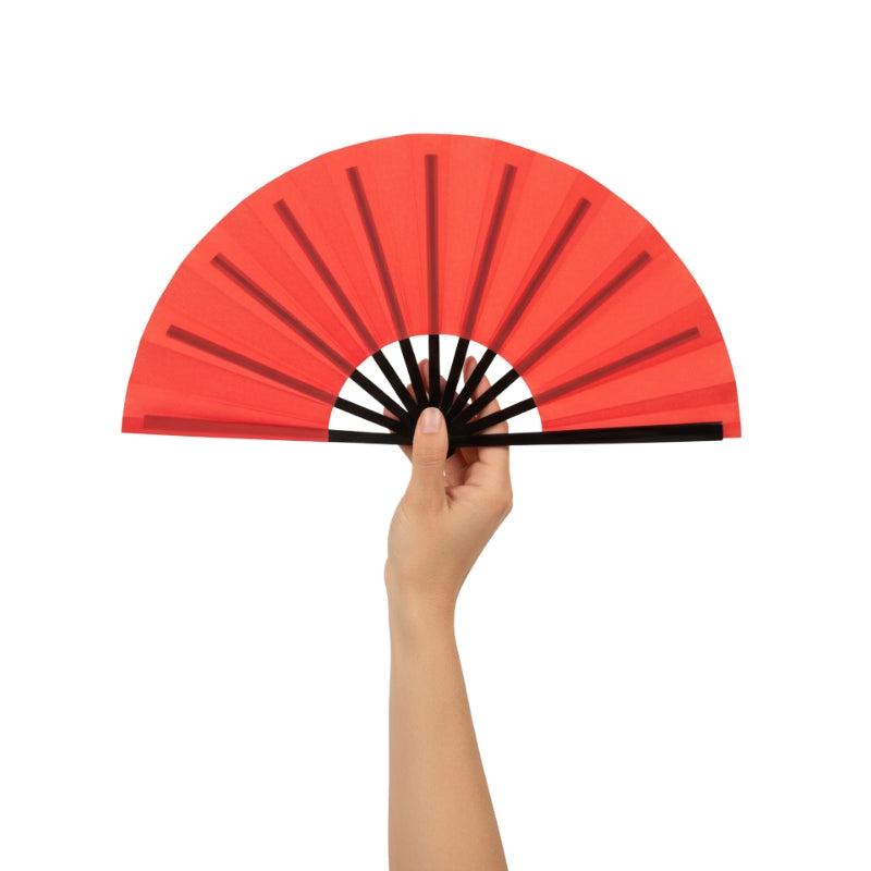 Beautiful red fan japanese with gradient coral shades held delicately in hand against minimalist white background highlighting fine details