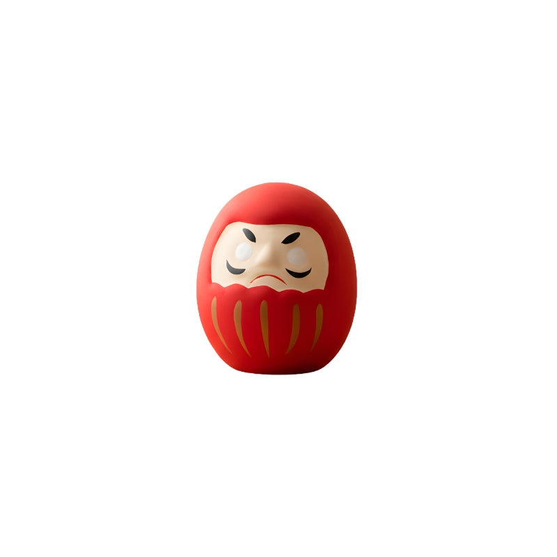 Good luck red japanese daruma in vibrant crimson finish with blank eyes isolated on clean white background showing traditional details