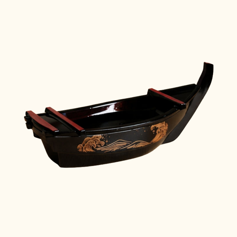 Sushi black boat curved serving platter with red dividers and gold wave motif on neutral white background