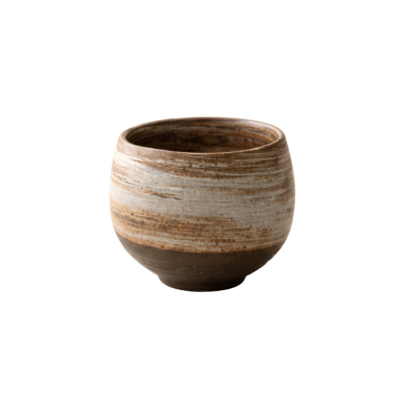 Tea japanese cup round pottery in round form with horizontal earth bands and dark base on clean white background