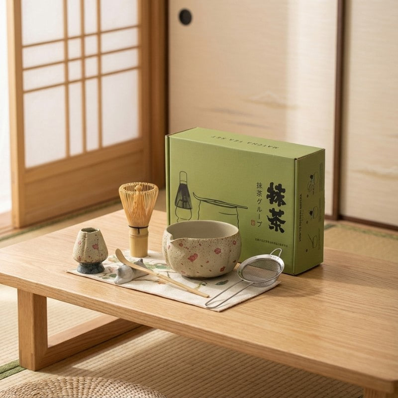 Complete tea set green matcha with pink flower pattern on wooden table near bright shoji window