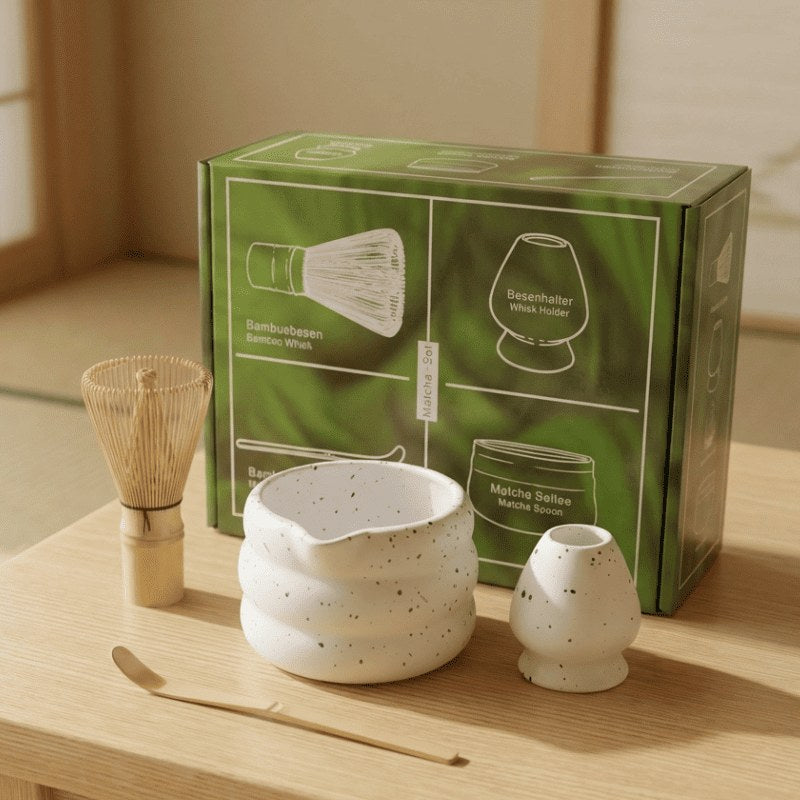 Four-piece tea set matcha white including ceramic bowl and bamboo scoop presented with green box on wooden table near shoji window
