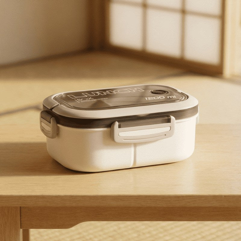 Professional white the bento box with gray transparent lid and secure buckles sitting on natural wood table in softly lit minimalist interior space
