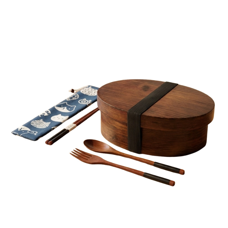 Dark brown wooden bento japanese box with elastic closure and patterned fabric pouch with complete utensil set on neutral white background
