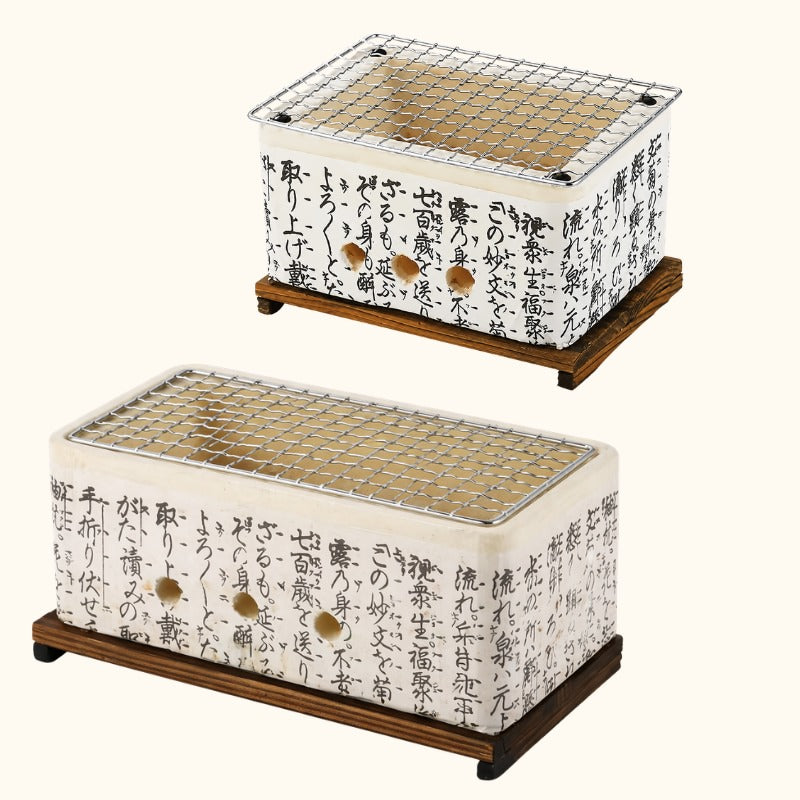 Small and big Japanese barbecue grills with white ceramic kanji calligraphy body and metal mesh grill on dark wood stands on neutral background